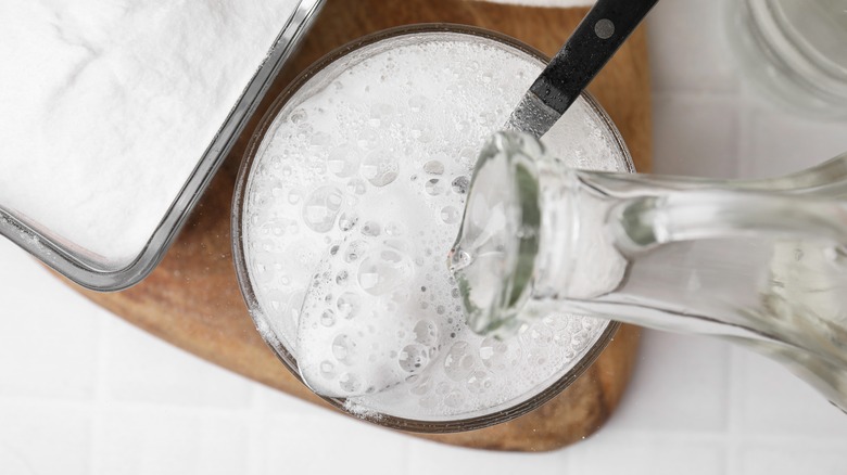 vinegar pouring onto baking soda