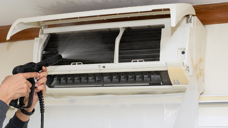 Cleaning air conditioner with water