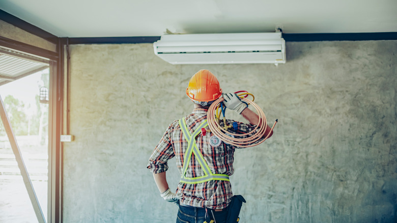 Technician examining air conditioner