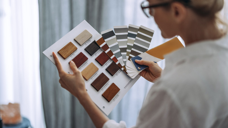 Photo of designer choosing colors for cabinet door paint