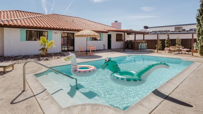 desert backyard pool with floaties 