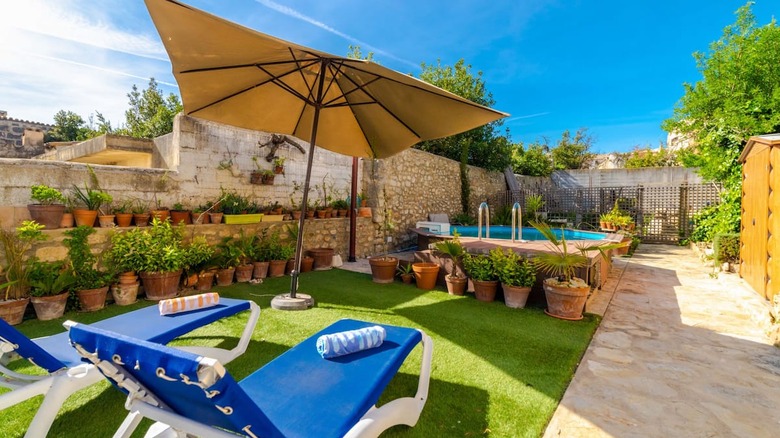 Outdoor area with small pool and umbrella 
