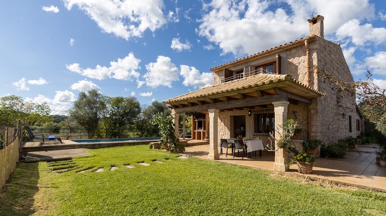 stone villa on grassy lawn 