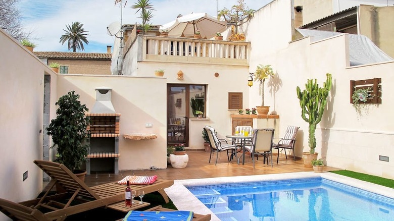 patio with pool and lounge chairs 