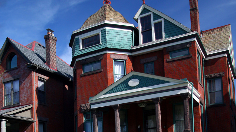 victorian village home with siding