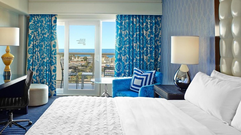 blue bedroom with ocean view balcony