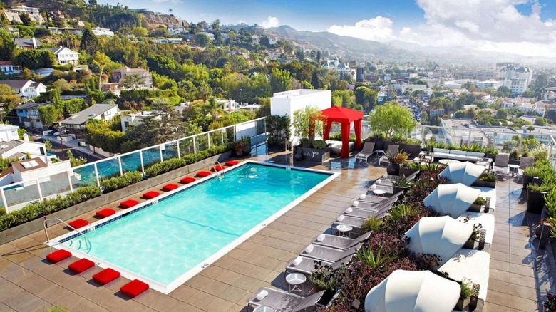 pool with red seats and view