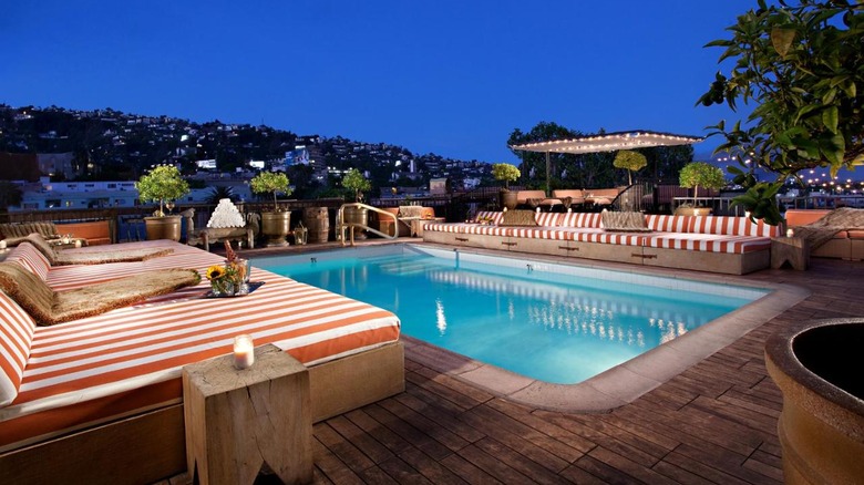 pool with striped lounge chairs