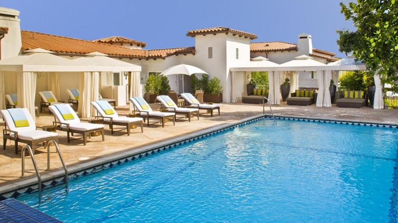 pool with cabanas and lounge chairs