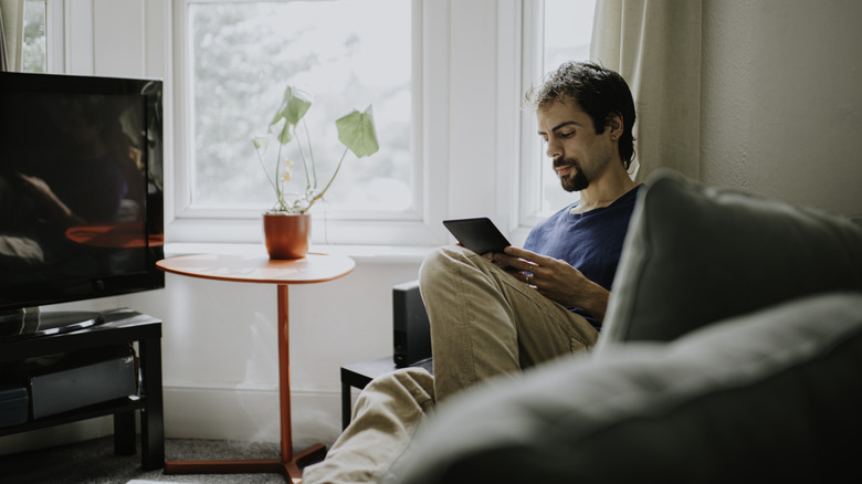 Man on sofa with tablet