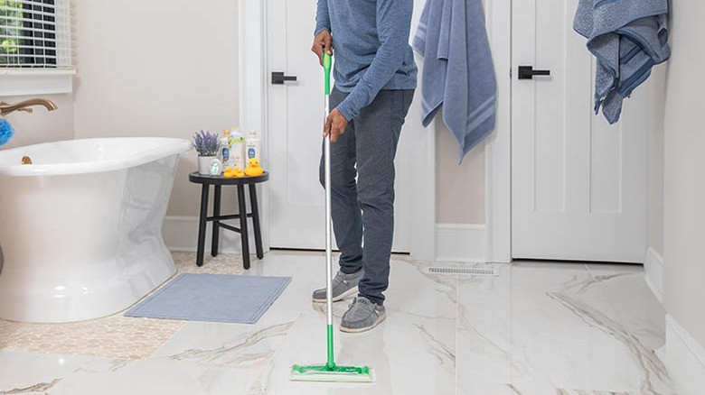 person using Swiffer 2-1 in bathroom