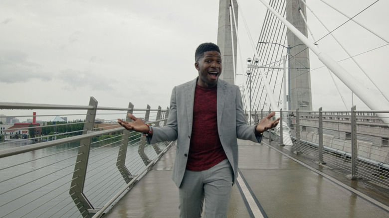 Andrew Tyree talking on a bridge