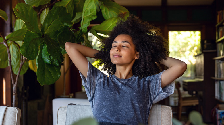 woman happily resting in chair