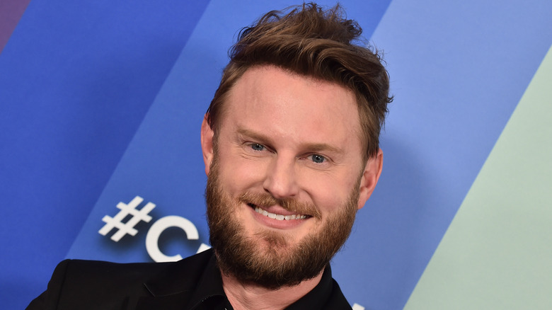 Bobby Berk smiles on the red carpet