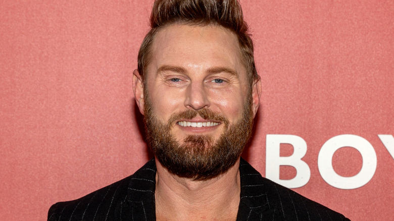 Bobby Berk smiling at a publicity event