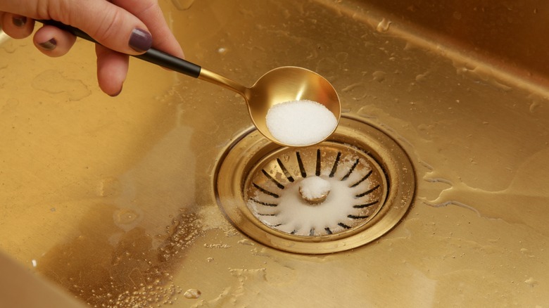 Pouring baking soda down drain