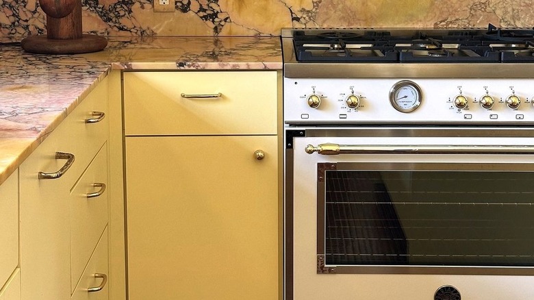 yellow cabinets with stone countertops