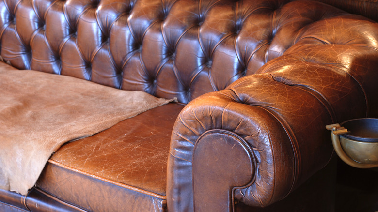 Brown leather couch with scratches