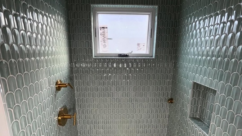 Dark green vertical tiles in shower