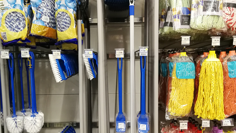Mop heads and other cleaning tools for sale in a homewares stores.