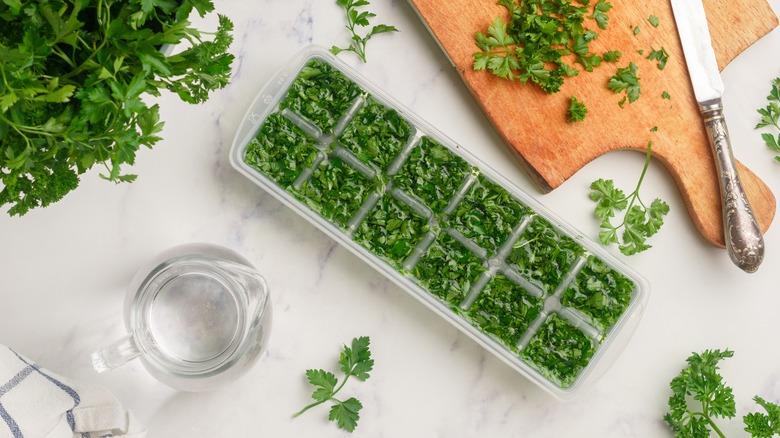chopped herbs in ice cube tray