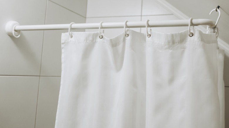 white shower curtain in bathroom