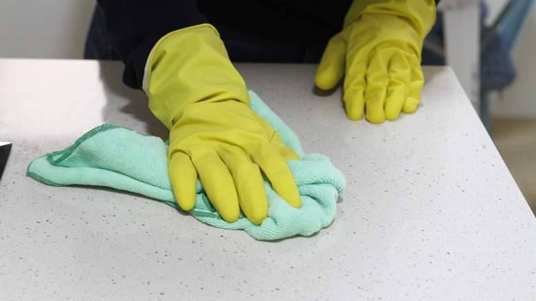 Person wiping counter with cloth