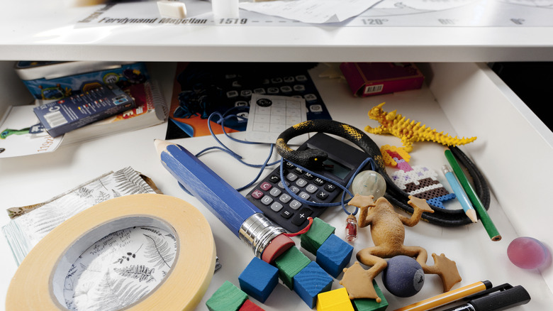 Cluttered drawer with assorted items