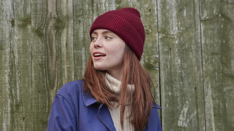 A woman wearing a red wool hat