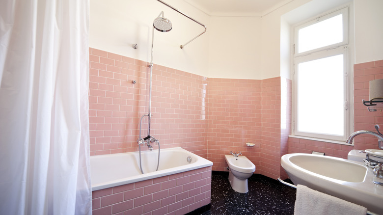 Bathroom with pink tiles and white fixtures