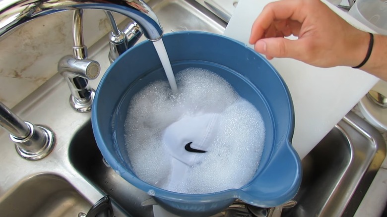 white cap soaking in soapy water