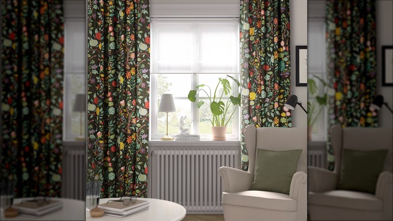 Dark multicolored floral curtains hang in a sitting room