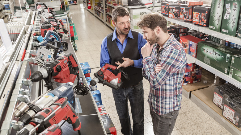 Two men shopping for power tools at the hardware store