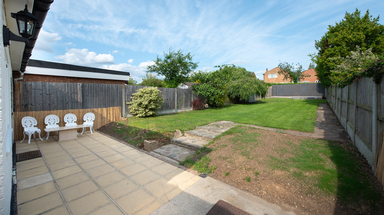 Backyard with patio and dirt spots