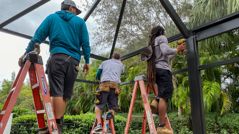 People building a patio enclosure