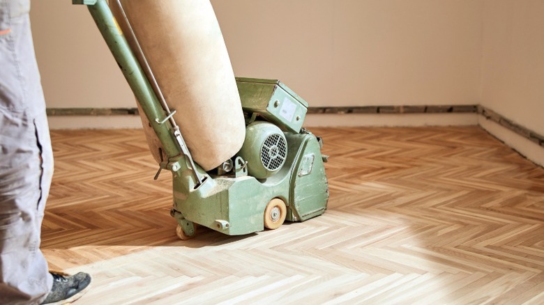 Sanding machine on parquet wood floor