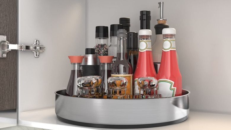 A lazy Susan with sauces in a cabinet