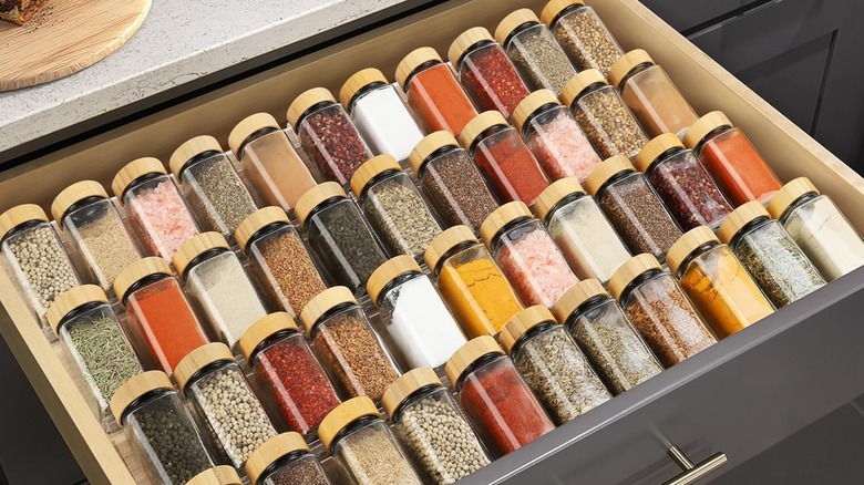 A four tier acrylic spice rack in a drawer