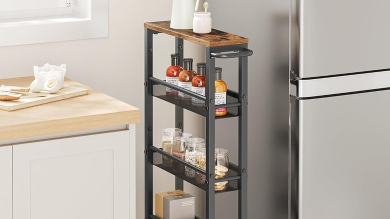 A slim rolling cart between the cabinets and refrigerator