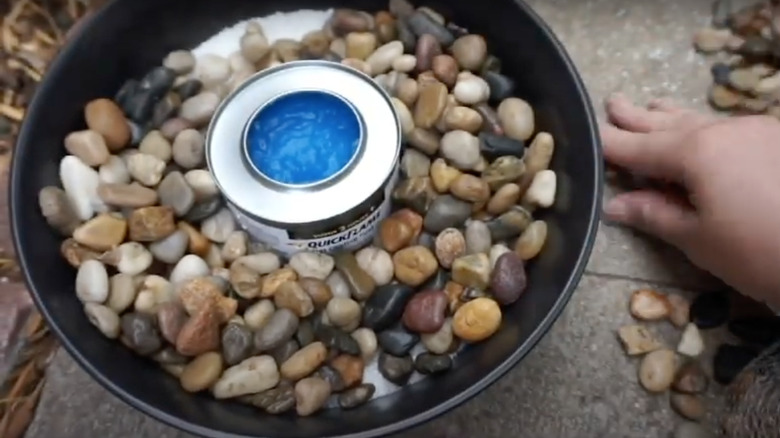 Adding stone to firepit pot