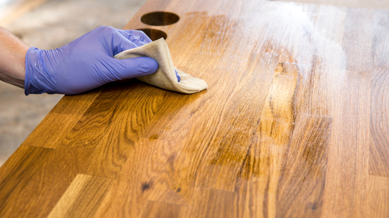 Applying oil to butcher block 