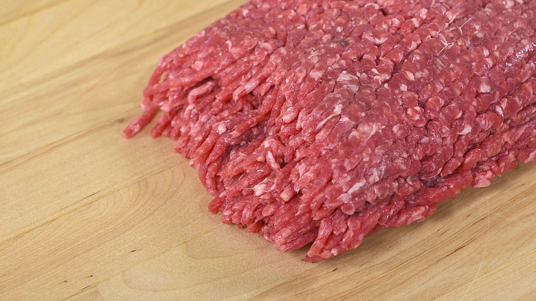 Ground beef on butcher block countertop