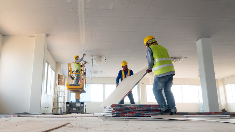 construction workers work on house