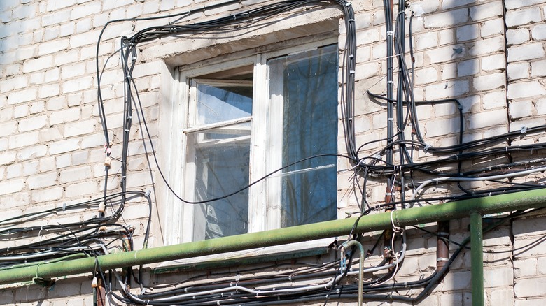 A tangle of cables mounted to wall