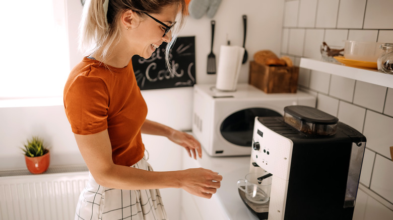 Woman using coffee machine