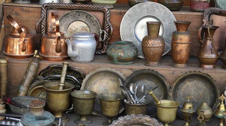 Tarnished metal items on a shelf