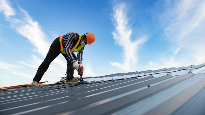 Worker on metal roof