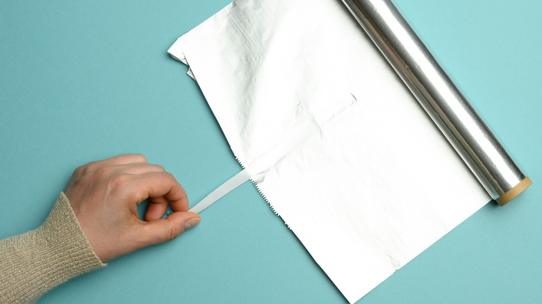 Hand unrolling aluminum foil