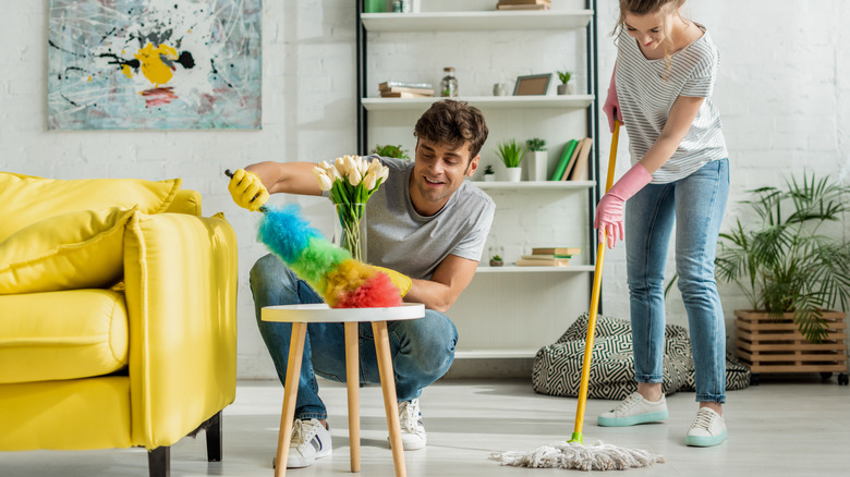 Couple cleaning their home