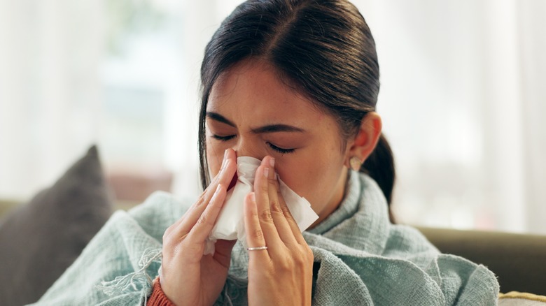 woman blowing her nose